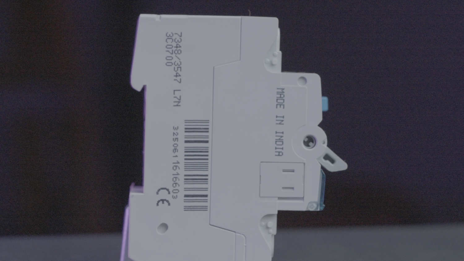 Close-up of the CE mark and Made in India stamp on an electrical protective device